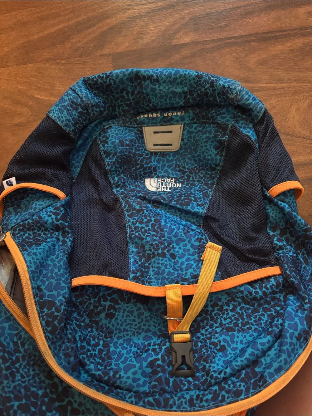 The North Face Recon Squash Teal Leopard Print Backpack with Orange Accents